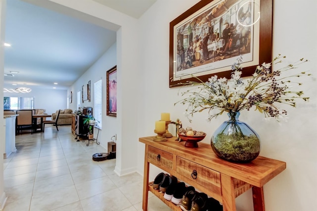 hallway with light tile patterned flooring and baseboards