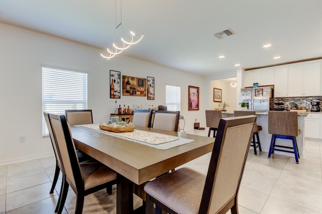 dining space featuring a chandelier, recessed lighting, light tile patterned flooring, and visible vents