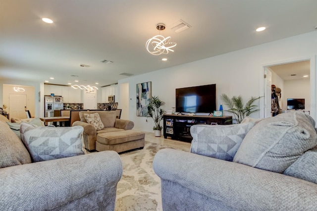 living room featuring an inviting chandelier, recessed lighting, and visible vents
