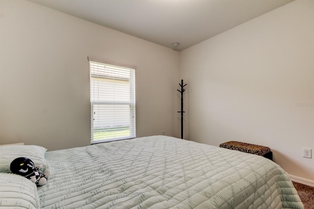 bedroom featuring carpet floors and baseboards