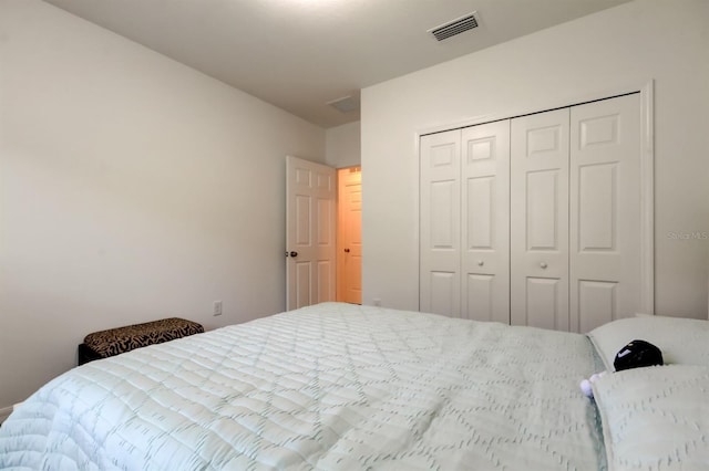 bedroom with a closet and visible vents