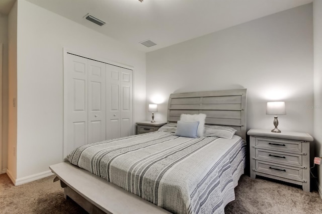 carpeted bedroom featuring visible vents, baseboards, and a closet