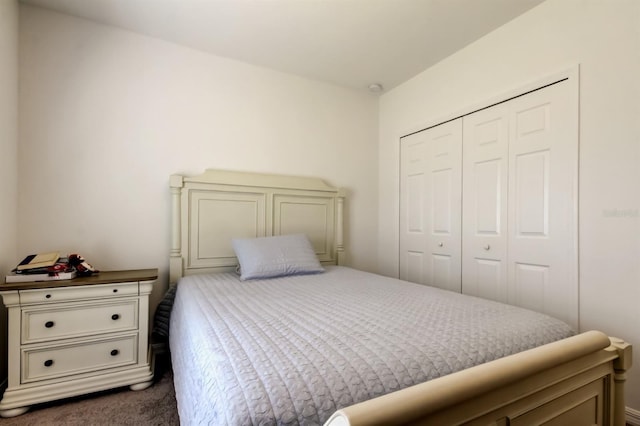 bedroom with dark carpet and a closet