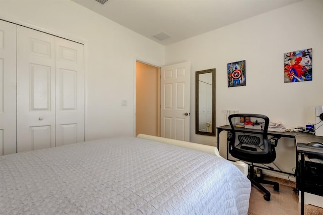 bedroom featuring a closet, carpet flooring, and visible vents
