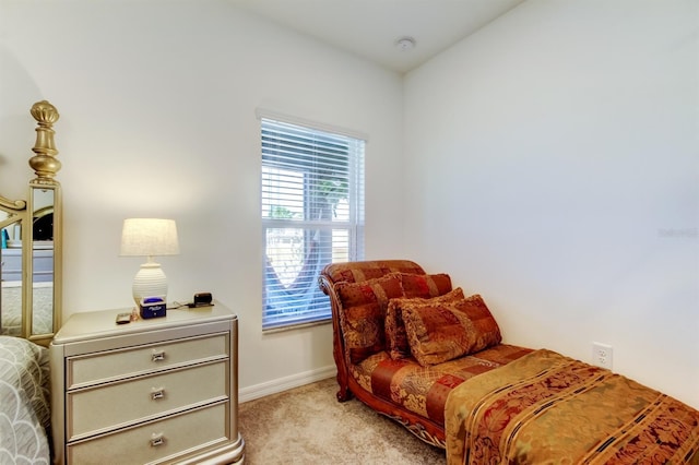 bedroom featuring baseboards and light carpet
