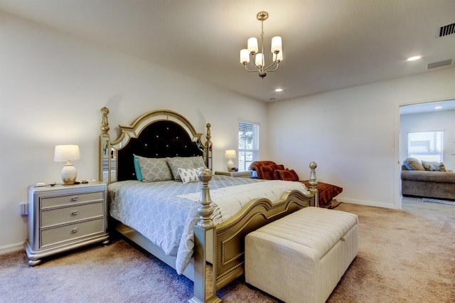 carpeted bedroom with baseboards, multiple windows, and a chandelier