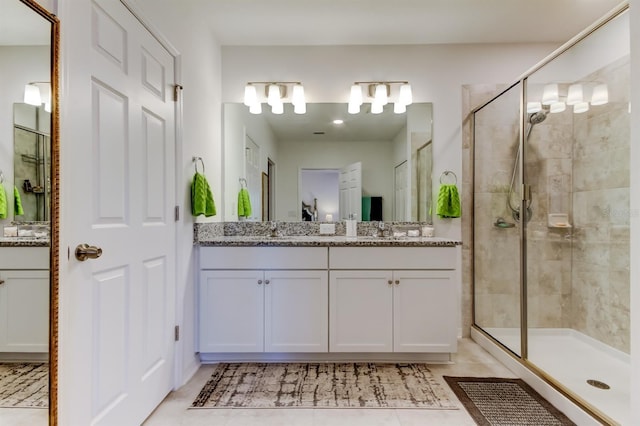 full bath featuring vanity, tile patterned floors, and a shower stall