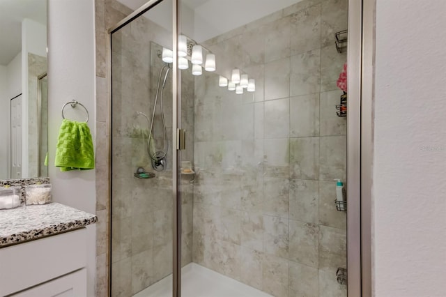 full bath with vanity and a stall shower