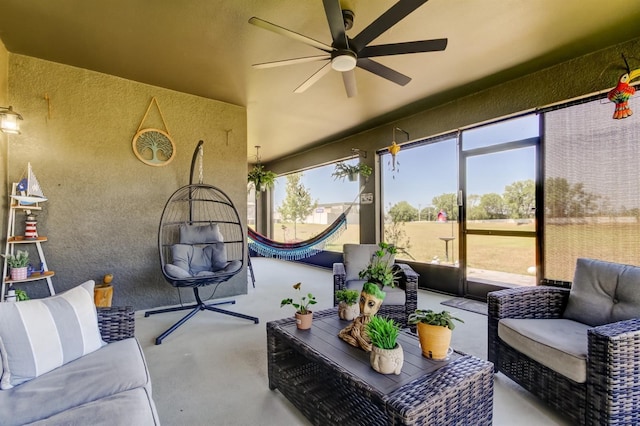 sunroom / solarium featuring an outdoor hangout area, a ceiling fan, and a healthy amount of sunlight