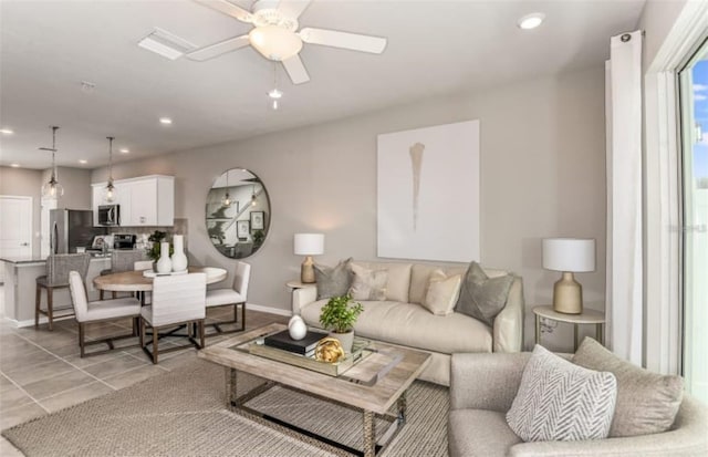 living room with light tile patterned floors, baseboards, ceiling fan, and recessed lighting