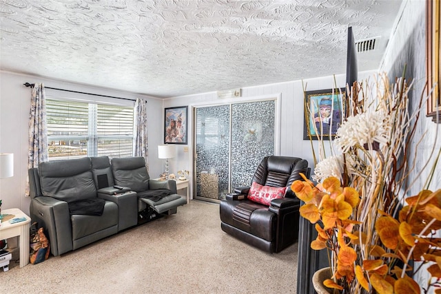 living area featuring a textured ceiling and visible vents
