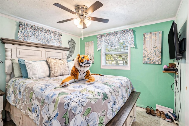bedroom featuring a ceiling fan, baseboards, ornamental molding, and a textured ceiling