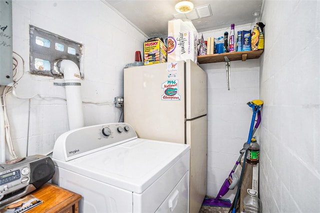 laundry room with laundry area, washer / clothes dryer, and concrete block wall