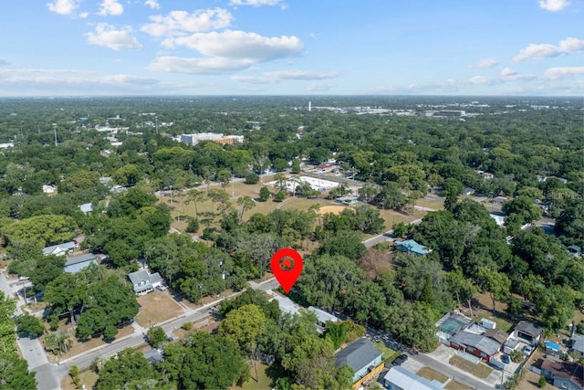 birds eye view of property featuring a wooded view