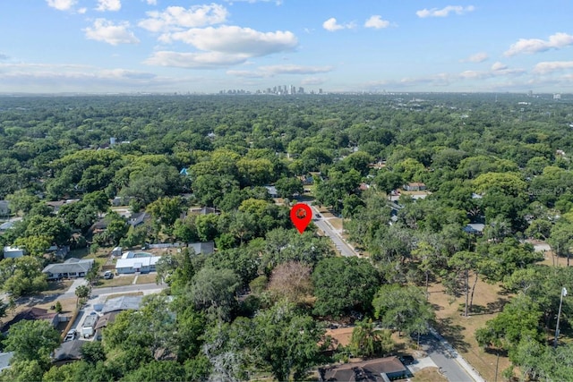 bird's eye view with a wooded view