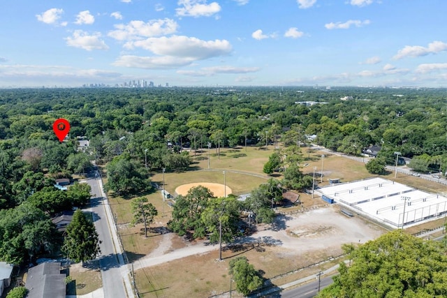 drone / aerial view featuring a wooded view