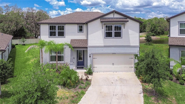 view of front of home with a front yard, a garage, fence, concrete driveway, and a shingled roof