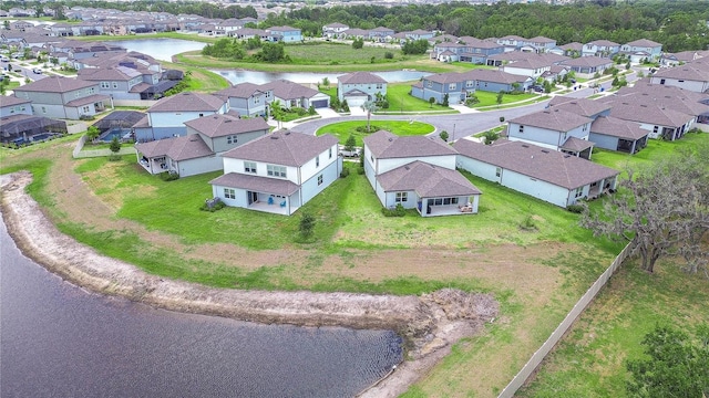birds eye view of property with a water view and a residential view