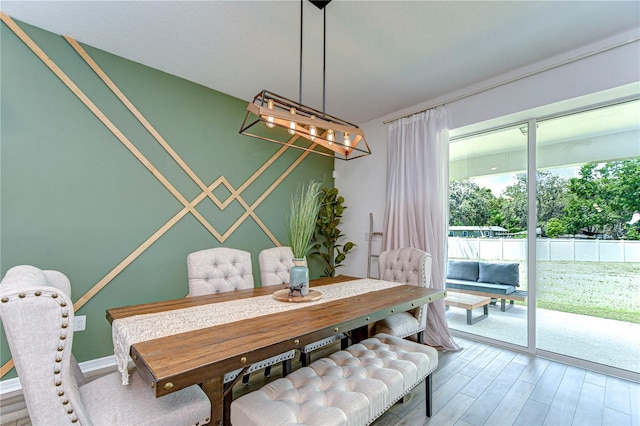 dining area with an inviting chandelier and wood finished floors