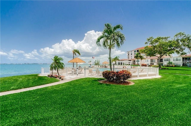 view of yard featuring fence and a water view