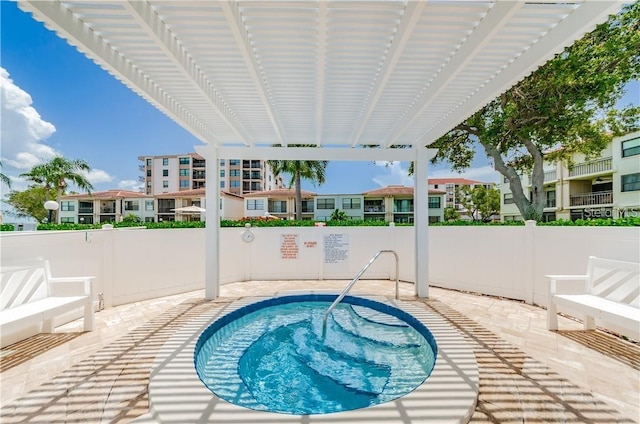 view of pool with fence, a patio, and a residential view