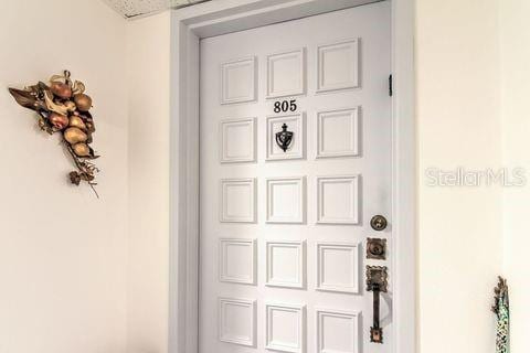 property entrance with stucco siding