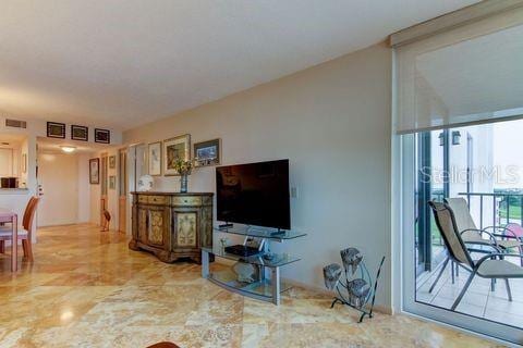 living room featuring expansive windows and visible vents