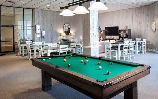 playroom featuring carpet flooring, wooden walls, a drop ceiling, and billiards