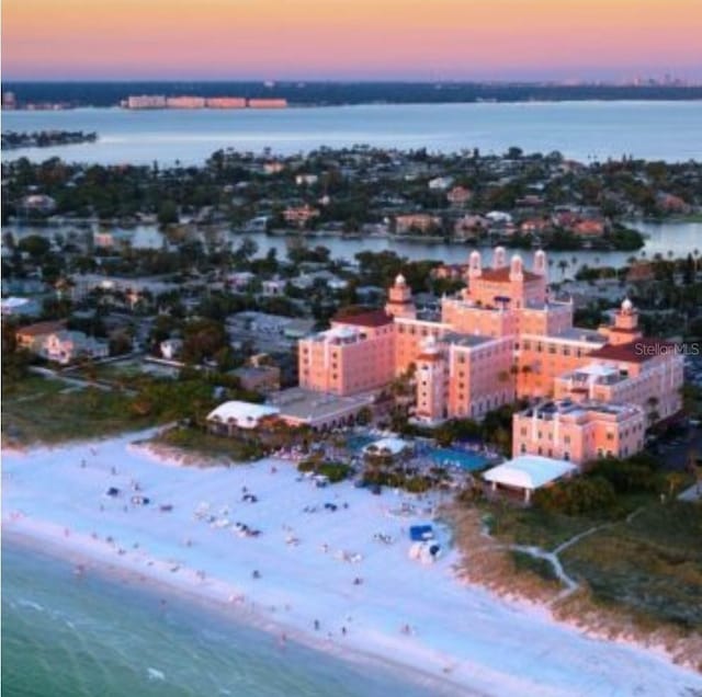 birds eye view of property featuring a water view and a beach view