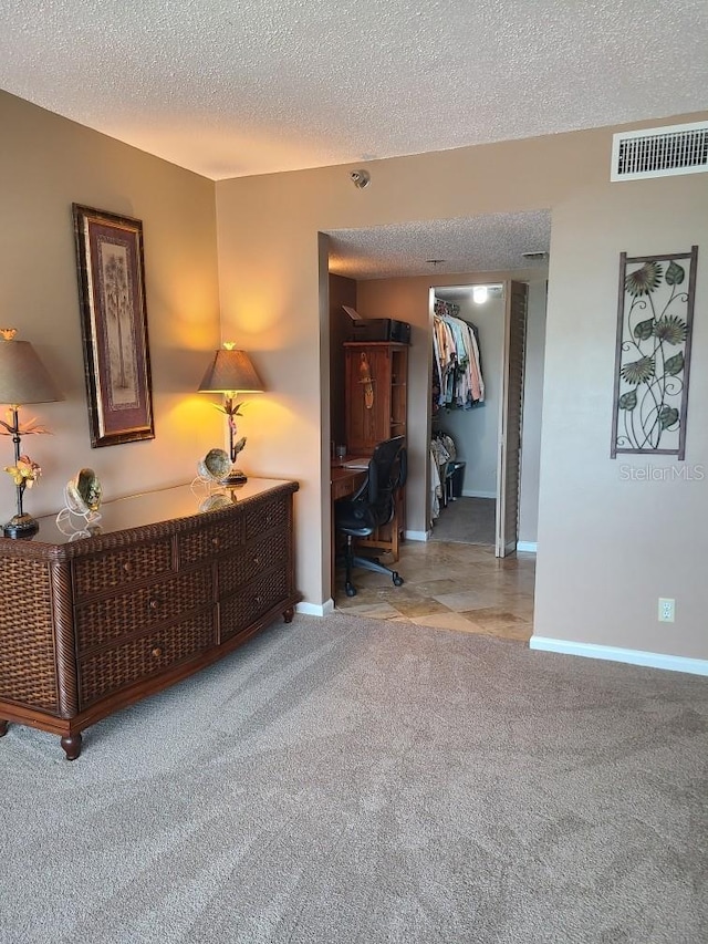 6265 Sun Blvd Unit 805, Saint Petersburg, FL 33715 - corridor featuring an office area, a textured ceiling, carpet floors, and baseboards