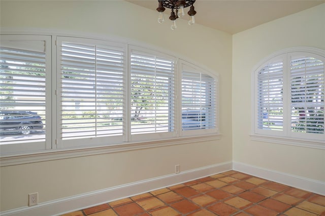 1606 S Arrawana Ave, Tampa, FL 33629 - spare room featuring baseboards, tile patterned flooring, and a chandelier