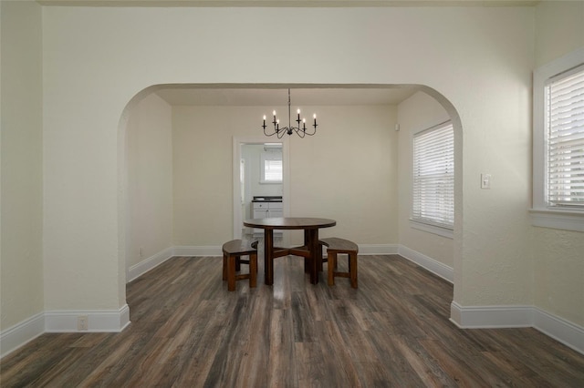 1606 S Arrawana Ave, Tampa, FL 33629 - dining space with arched walkways, dark wood finished floors, and a healthy amount of sunlight