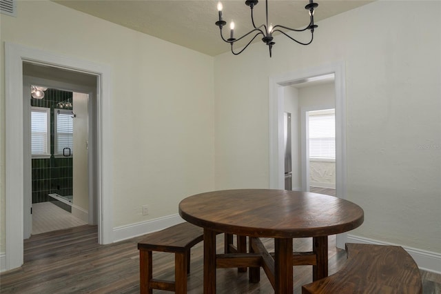 1606 S Arrawana Ave, Tampa, FL 33629 - dining area with baseboards, wood finished floors, and a notable chandelier