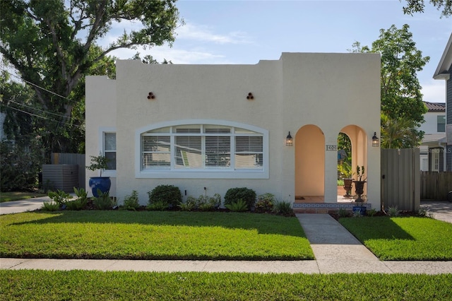 1606 S Arrawana Ave, Tampa, FL 33629 - mediterranean / spanish-style house with a front lawn, stucco siding, and fence