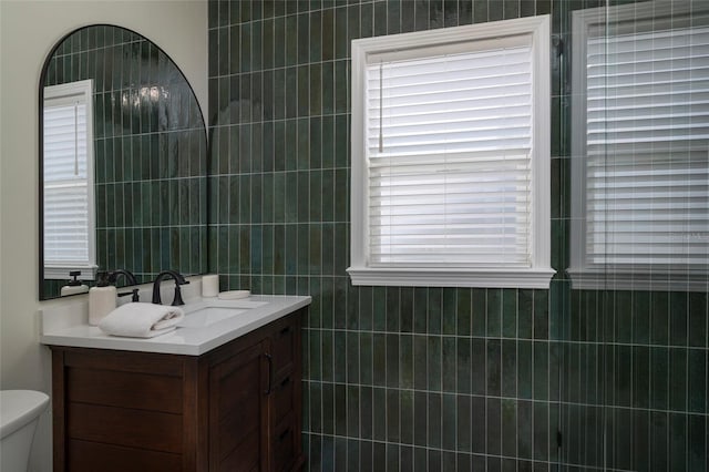 1606 S Arrawana Ave, Tampa, FL 33629 - bathroom with toilet, tile walls, and vanity