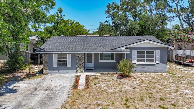10931 110th Ave, Seminole, FL 33778 - view of front of house featuring roof with shingles and a porch