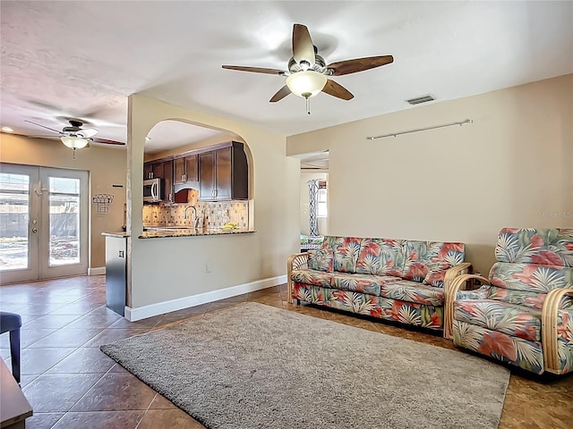 10931 110th Ave, Seminole, FL 33778 - living area with ceiling fan, healthy amount of natural light, and french doors