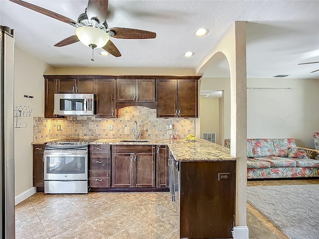 10931 110th Ave, Seminole, FL 33778 - kitchen featuring appliances with stainless steel finishes, ceiling fan, a sink, tasteful backsplash, and recessed lighting