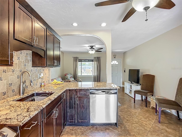 10931 110th Ave, Seminole, FL 33778 - kitchen with stainless steel dishwasher, a ceiling fan, a sink, a peninsula, and backsplash
