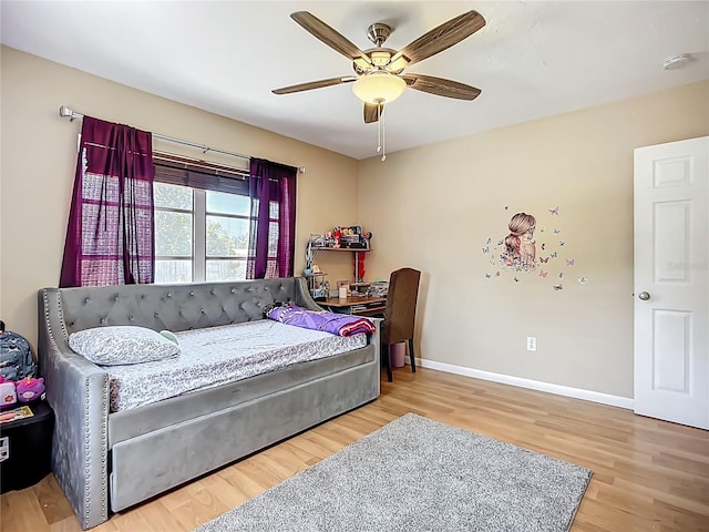 10931 110th Ave, Seminole, FL 33778 - bedroom featuring wood finished floors, baseboards, and a ceiling fan
