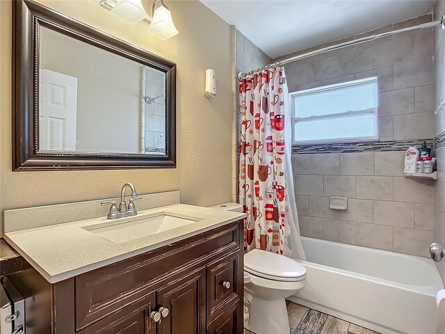 10931 110th Ave, Seminole, FL 33778 - bathroom with toilet, vanity, shower / tub combo with curtain, and a textured wall