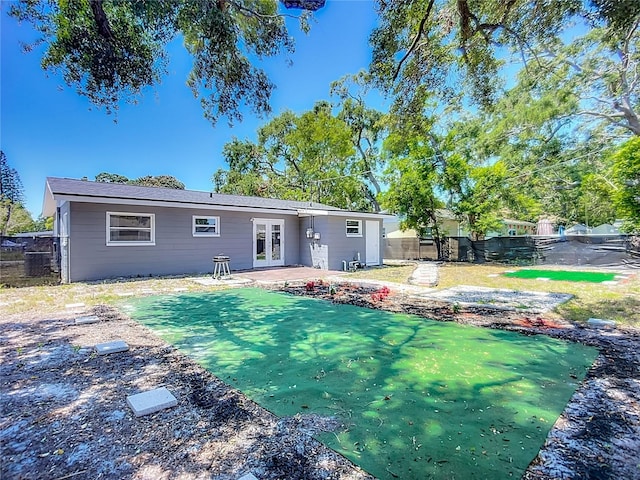 10931 110th Ave, Seminole, FL 33778 - rear view of property with french doors and a patio area