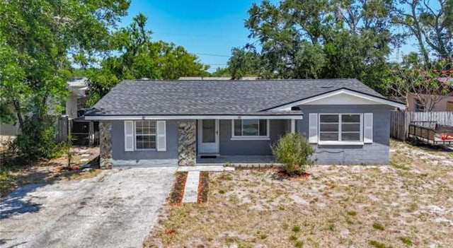 10931 110th Ave, Seminole, FL 33778 - single story home featuring a porch, roof with shingles, and driveway