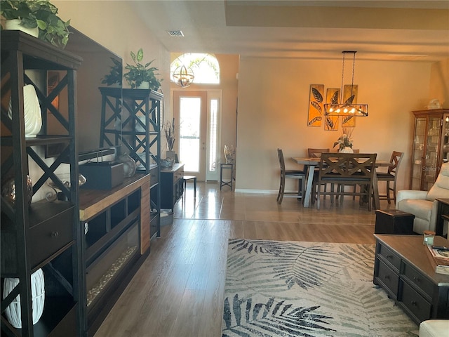 living area with visible vents, a chandelier, and a wealth of natural light