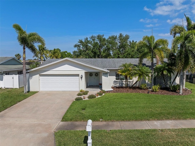 1849 Del Robles Dr, Clearwater, FL 33764 - ranch-style home featuring concrete driveway, an attached garage, fence, and a front yard