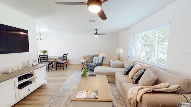 1849 Del Robles Dr, Clearwater, FL 33764 - living area featuring visible vents, ceiling fan with notable chandelier, and light wood-type flooring