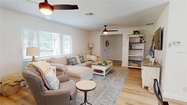 1849 Del Robles Dr, Clearwater, FL 33764 - living area with visible vents, light wood finished floors, ceiling fan, and baseboards