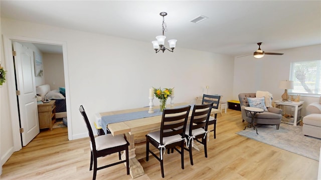 1849 Del Robles Dr, Clearwater, FL 33764 - dining space with baseboards, visible vents, light wood finished floors, and ceiling fan with notable chandelier