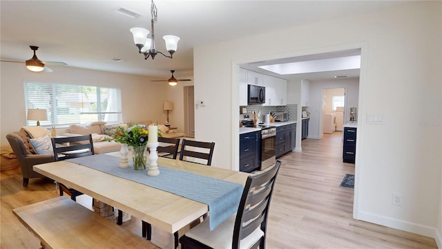 1849 Del Robles Dr, Clearwater, FL 33764 - dining room featuring light wood finished floors, a wealth of natural light, and ceiling fan with notable chandelier