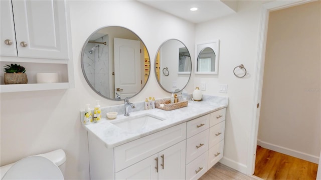 1849 Del Robles Dr, Clearwater, FL 33764 - bathroom featuring vanity, toilet, recessed lighting, baseboards, and wood finished floors